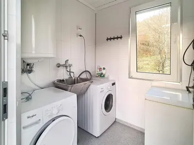 a laundry room with a washing machine and a sink at 5 person holiday home in LONEVÅG-By Traum in Lonevåg