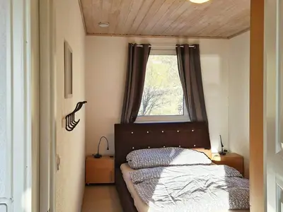 a small bedroom with a bed and a window at 5 person holiday home in LONEVÅG-By Traum in Lonevåg
