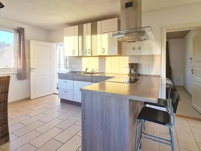 a kitchen with white cabinets and a counter top at 5 person holiday home in LONEVÅG-By Traum in Lonevåg