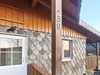 a house with a door and a sign on it at 5 person holiday home in LONEVÅG-By Traum in Lonevåg