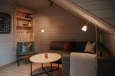 a living room with a couch and a table at Fanøy Island Lodge in Fanoyna