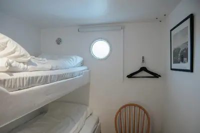 a room with two bunk beds and a window at Fanøy Island Lodge in Fanoyna