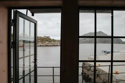 an open window with a view of a body of water at Fanøy Island Lodge in Fanoyna