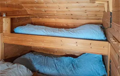 two beds in a sauna in a wooden cabin at 4 Bedroom Nice Home In Etne in Etnesjøen