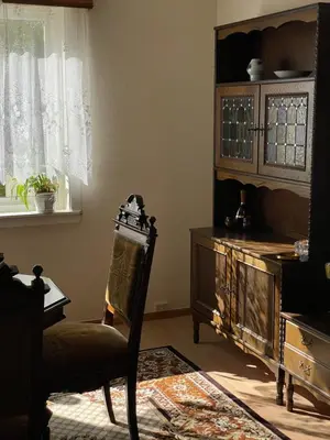 a room with a chair and a cabinet and a window at Svingen Guesthouse - Panoramic Fjord Views in Flåm in Flåm