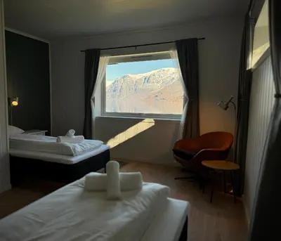 a hotel room with two beds and a window at Svingen Guesthouse - Panoramic Fjord Views in Flåm in Flåm
