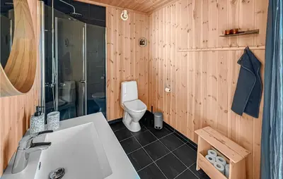 a bathroom with a white sink and a toilet at Stunning Home In Øyer With Sauna in Øyer