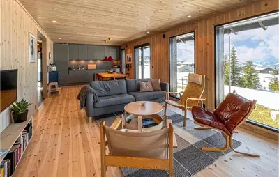 a living room with a couch and a table at Stunning Home In Øyer With Sauna in Øyer