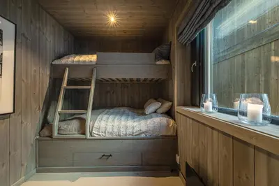 a bedroom with bunk beds in a wooden room at Mountain nest in Hemsedal close to the ski slopes in Hemsedal