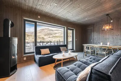 a living room with a couch and a table at Mountain nest in Hemsedal close to the ski slopes in Hemsedal