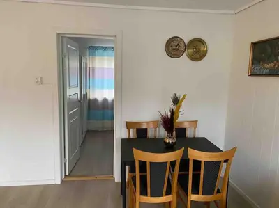 a dining room with a black table and chairs at Lovely 2 bedroom apartmen with free parking in Bergen