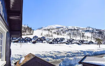 a view of a snowy mountain from a house at Gorgeous Home In Rauland in Rauland