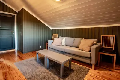 a living room with a couch and a table at Storsten 730 in Trysil