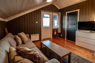 a living room with a couch and a tv at Storsten 730 in Trysil