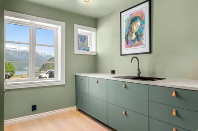 a kitchen with a sink and a window at Trolltunga View in Tysso