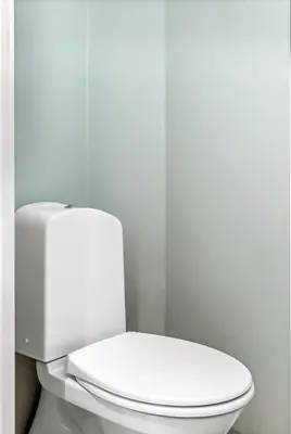 a white toilet in a bathroom with a white wall at Trolltunga View in Tysso