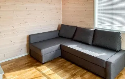 a gray couch in a room with a wall at Gorgeous Home In Sveio With Wifi in Sveio