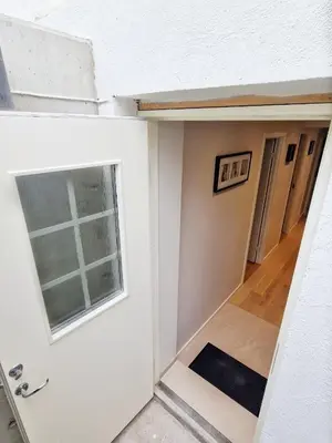 an empty room with a window and a door at Ibsens apartaments in Bergen