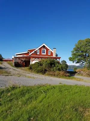 a house on the side of a road at Leilighet Vikaparken Hardangerfjord in Hatlestrand