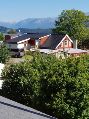 a house with solar panels on its roof at Leilighet Vikaparken Hardangerfjord in Hatlestrand