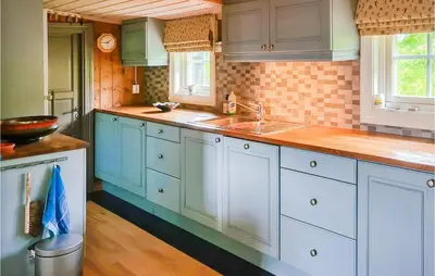 a kitchen with blue cabinets and a sink at 3 Bedroom Lovely Home In Beitostølen in Beitostøl