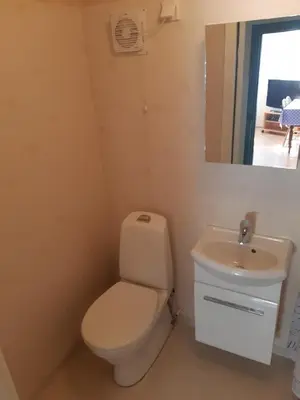 a bathroom with a toilet and a sink at Westerås Gard in Geiranger