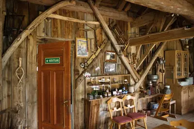 a room with a bar in a wooden cabin at Westerås Gard in Geiranger