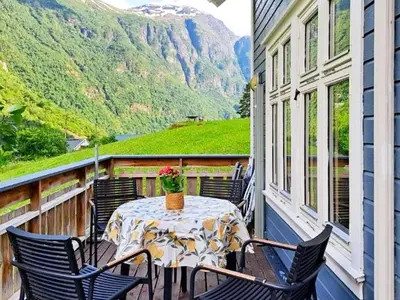 a table on a balcony with a view of a mountain at 6 person holiday home in Gudvangen-By Traum in Gudvangen