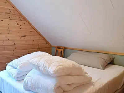 a bed with white sheets and pillows in a room at 6 person holiday home in Gudvangen-By Traum in Gudvangen