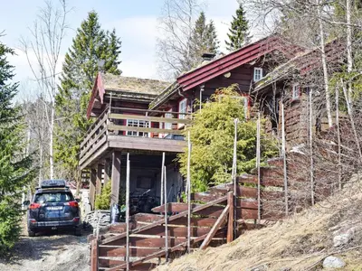 a car parked in front of a log house at 6 person holiday home in HURDAL-By Traum in Hurdal