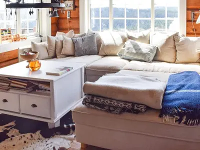 a living room with a couch and a table at 6 person holiday home in HURDAL-By Traum in Hurdal