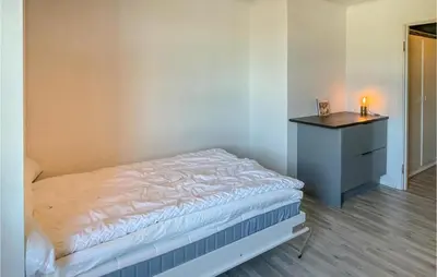 a small bedroom with a bed and a dresser at Lovely Apartment In Tisleidalen in Golsfjellet