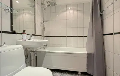 a bathroom with a sink and a toilet and a bath tub at Lovely Apartment In Tisleidalen in Golsfjellet