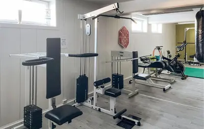 a gym with several treadmills and exercise bikes at Lovely Apartment In Tisleidalen in Golsfjellet