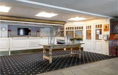 a large kitchen with a wooden table in it at Lovely Apartment In Tisleidalen in Golsfjellet