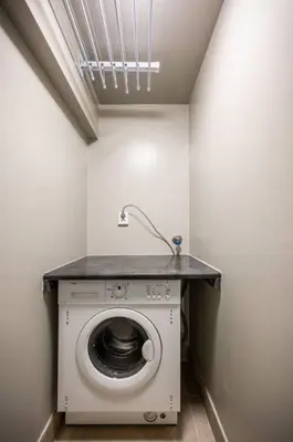 a washing machine in a room with a sink at Dinbnb Homes I 4-Bedroom Historical House in Romantic Surroundings in Bergen