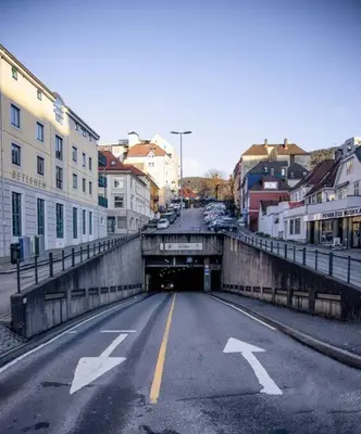 an empty street with a tunnel in a city at Dinbnb Homes I 4-Bedroom Historical House in Romantic Surroundings in Bergen
