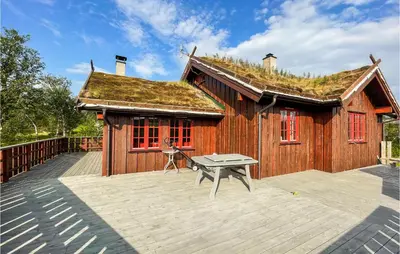 a building with a roof with a bench on a deck at 4 Bedroom Cozy Home In Reinli in Reinli