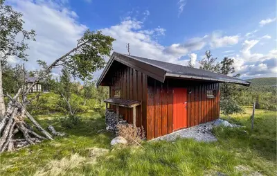 a small wooden cabin in a field of grass at 4 Bedroom Cozy Home In Reinli in Reinli