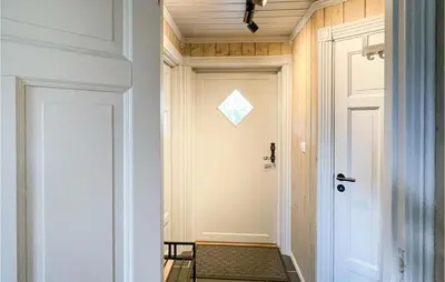 a hallway with a white door with a window at 4 Bedroom Cozy Home In Reinli in Reinli