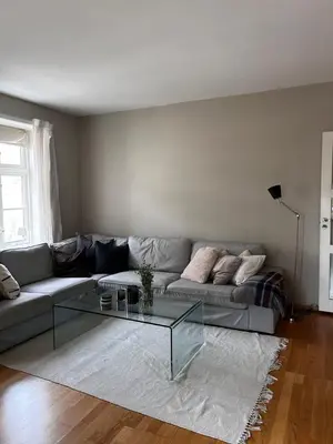 a living room with a couch and a glass table at Modern Apartment in the center of Bergen in Bergen