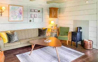 a living room with a couch and a wood stove at Stunning Home In Ålesund With Kitchen in Ålesund
