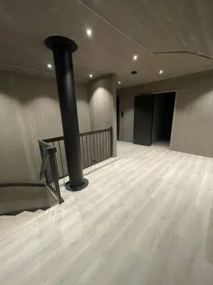 a large empty room with a black pole on a wooden floor at Resvegen 63 in Stranda