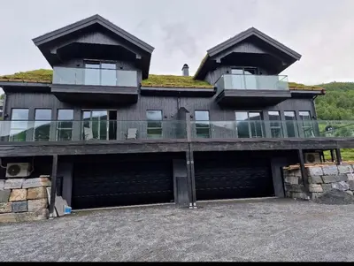 a large building with two balconies on top of it at Resvegen 63 in Stranda