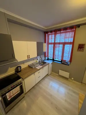 an empty kitchen with a sink and a window at Leilighet i Ålesund. in Ålesund