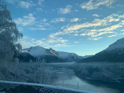 a view of a river in a valley with mountains at Solvik #apartment #Loen in Loen