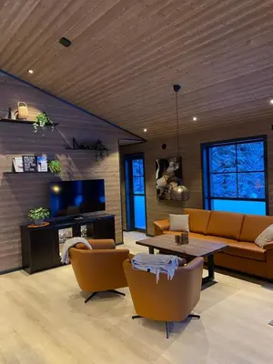 a living room with a couch and a table and chairs at Stryn Mountain Lodge in Stryn