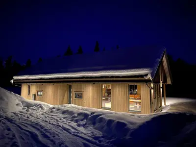 a building covered in snow at night with snow at Stryn Mountain Lodge in Stryn