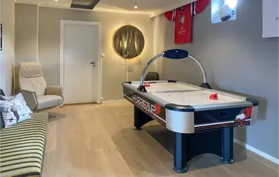 a room with a ping pong table in a room at Pet Friendly Apartment In Tresfjord in Tresfjord