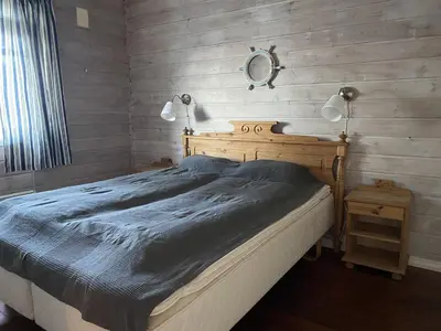a bedroom with a bed and a mirror and a sink at Rosendal Hyttetun in Rosendal